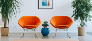 burnerai_two_orange_mid_century_modern_chairs_in_front_of_a_w_cbe80256-5f81-49ef-9341-3034f7b0dc93_3-1